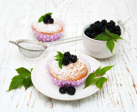 muffins with blackberry on a old wooden backgroundの写真素材