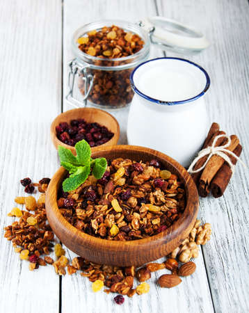 Homemade granola with nuts and milk  on a wooden tableの写真素材
