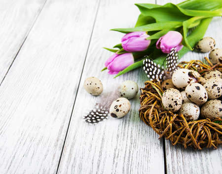 quail eggs in nest on a old wooden table