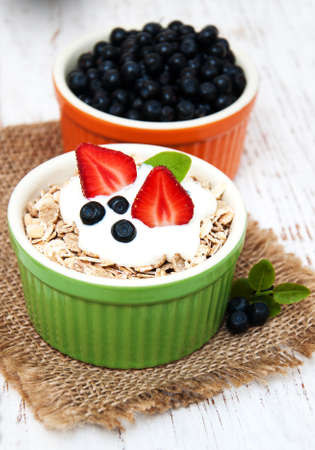 Muesli with berries on a old wooden background
