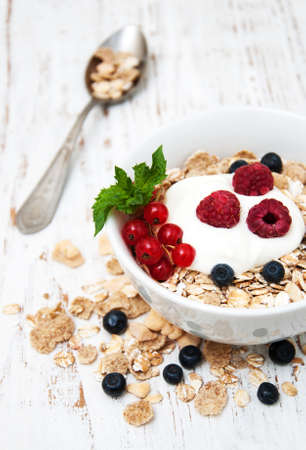 breakfast with fresh berries on a old wooden table