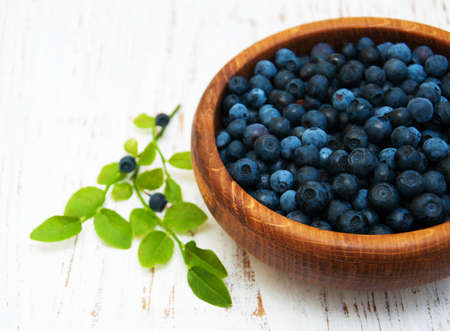 Bowl with Blueberries on a old wooden backgroundの写真素材