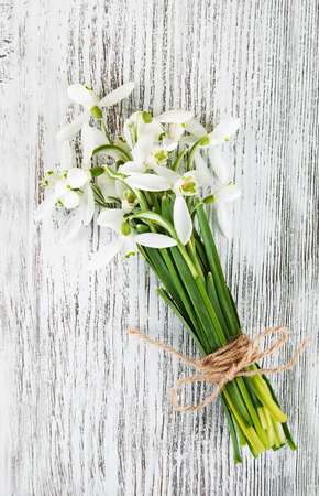 bouquet of snowdrops on a old wooden table