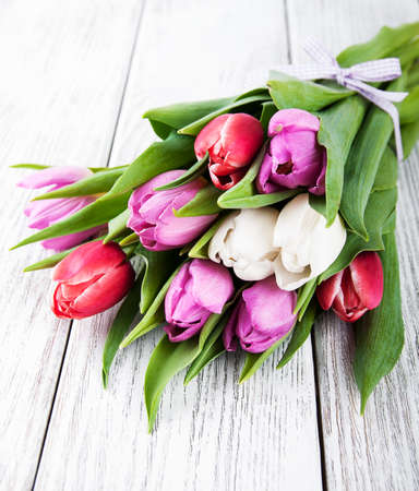 bouquet of tulips on a old wooden tableの写真素材