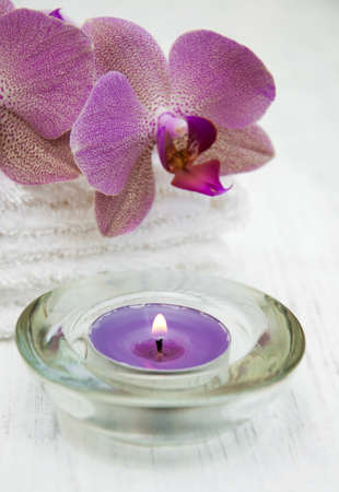 Pink orchids and towels on a wooden backgroundの写真素材