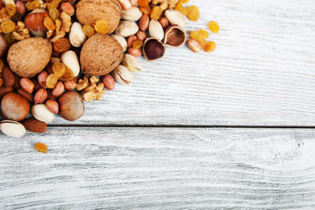 different types of nuts on a old wooden tableの写真素材