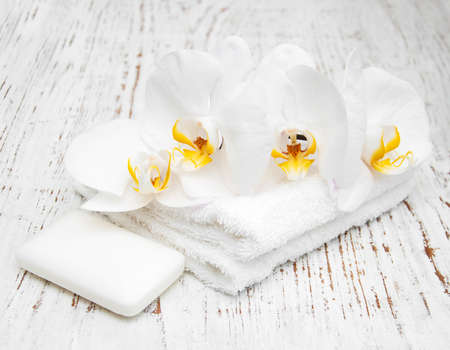 Orchids and spa towels on a wooden backgroundの写真素材