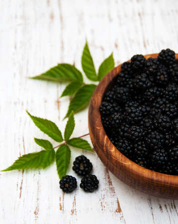 Bowl with Blackberries on a old wooden backgroundの写真素材