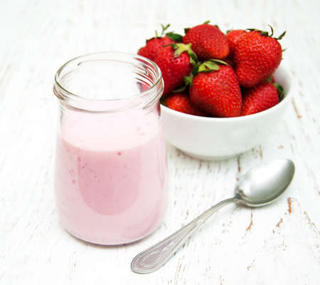 Strawberry yogurt with fresh strawberries on a wooden backgroundの写真素材