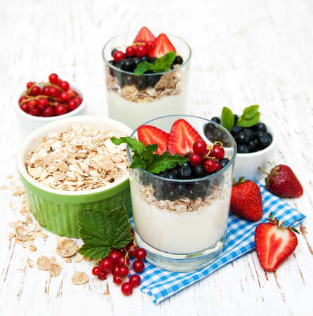 Yogurt with fresh berries on a wooden backgroundの写真素材