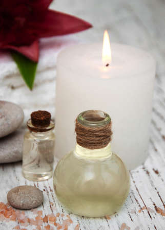 Spa products with pink lily on a old wooden backgroundの写真素材