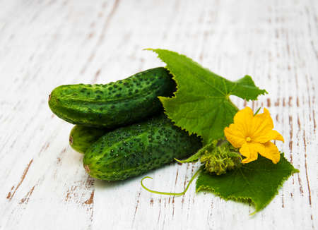 Fresh cucumbers on a old wooden backgroundの写真素材