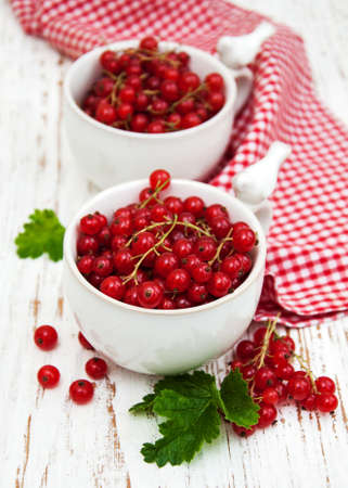 fresh red currant on a old wooden tableの写真素材