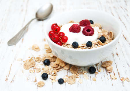 breakfast with fresh berries on a old wooden tableの写真素材