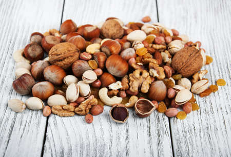 different types of nuts on a old wooden tableの写真素材