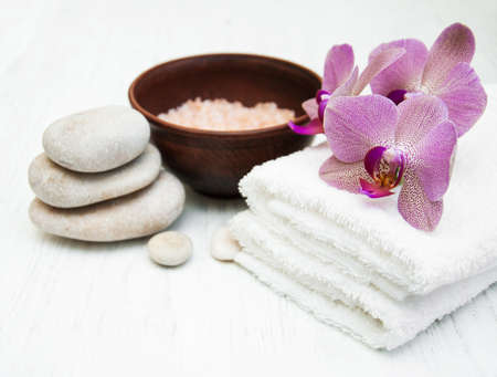 pink orchids and salt on a wooden backgroundの写真素材