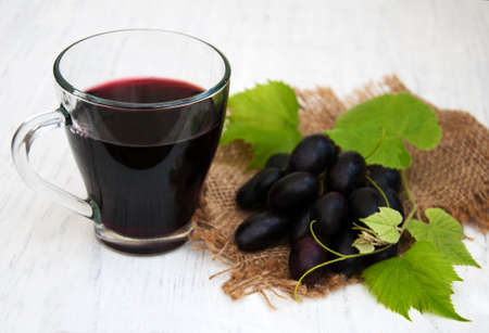 Glass with wine on a old wooden backgroundの写真素材