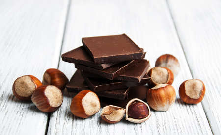 chocolate with nuts on a old wooden tableの写真素材