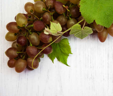 grape with leaf on a old wooden backgroundの写真素材