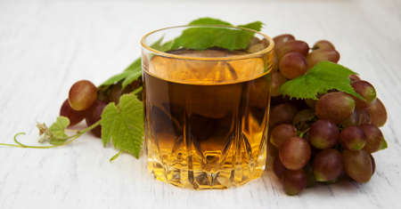 Glass with wine  on a wooden backgroundの写真素材