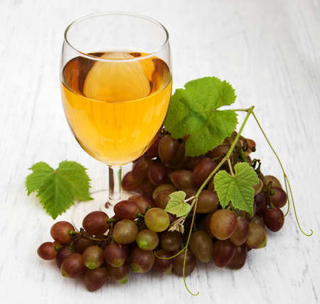 Glass with wine  on a wooden backgroundの写真素材