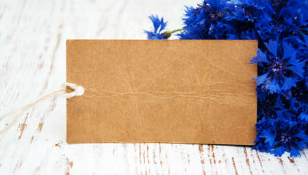 bouquet of blue Cornflowers and card on a old wooden backgroundの写真素材