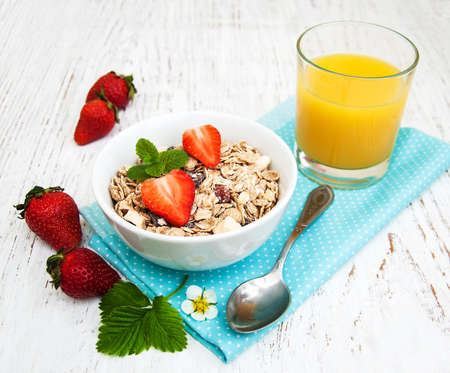 Muesli with strawberries on a old wooden backgroundの写真素材