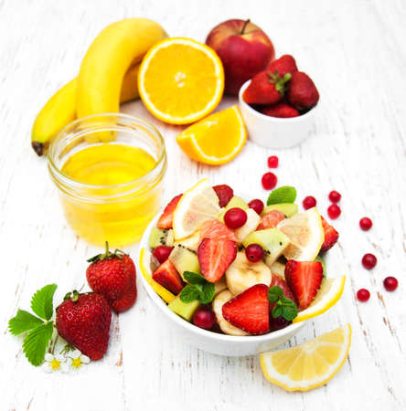 Salad with fresh fruits on a old wooden backgroundの写真素材
