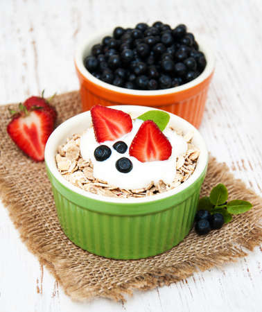 Muesli with berries on a old wooden backgroundの写真素材