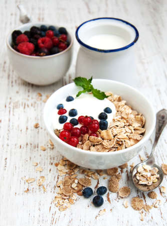 breakfast with fresh berries on a old wooden tableの写真素材