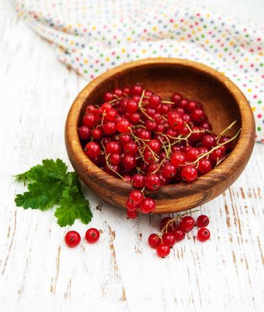 fresh red currant on a old wooden tableの写真素材