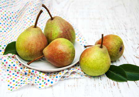 Fresh pears on a old wooden backgroundの写真素材