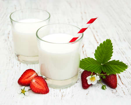 Milk and strawberries on a wooden backgroundの写真素材