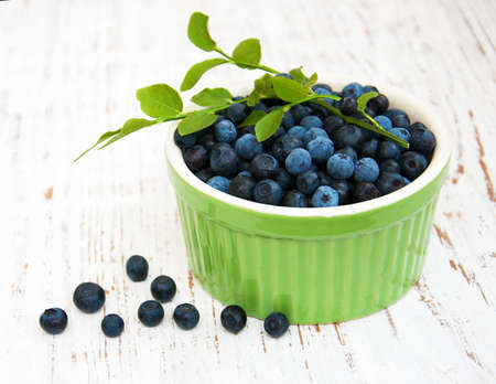 Bowl with Blueberries on a old wooden backgroundの写真素材