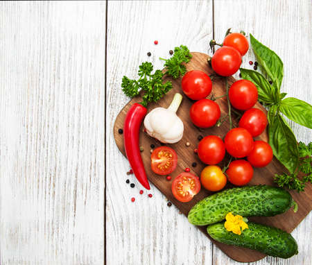 Fresh summer vegetables on a old wooden tableの写真素材