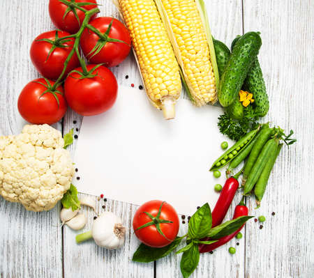 fresh vegetables as a frame on a old wooden tableの写真素材