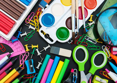 school office supplies  on a chalkboard backgroundの写真素材
