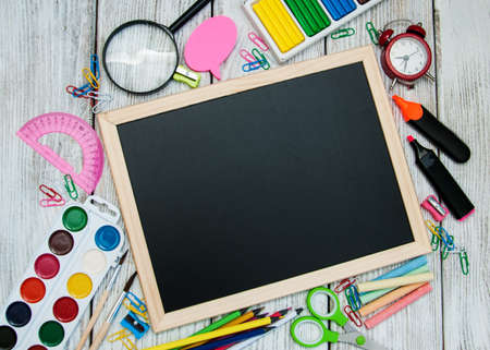 school office supplies  on a chalkboard backgroundの写真素材