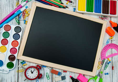 school office supplies  on a chalkboard backgroundの写真素材