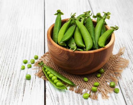 green peas  on rustic white wooden backgroundの写真素材