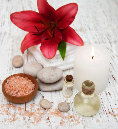 Spa products with pink lily on a old wooden backgroundの写真素材