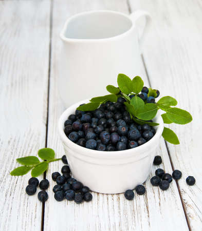 Bowl with Blueberries on a old wooden backgroundの写真素材