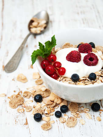 breakfast with fresh berries on a old wooden tableの写真素材