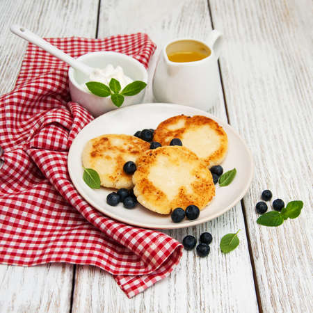 cottage cheese pancake with blueberry on a wooden tableの写真素材