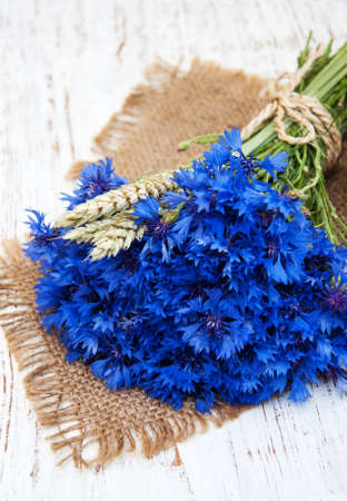 blue cornflowers on a old white wooden backgroundの写真素材