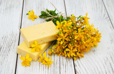 St. John's wort flowers and  handmade soap on the tableの写真素材