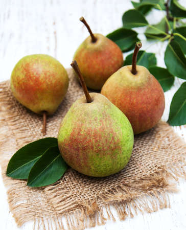 Fresh pears on a old wooden backgroundの写真素材