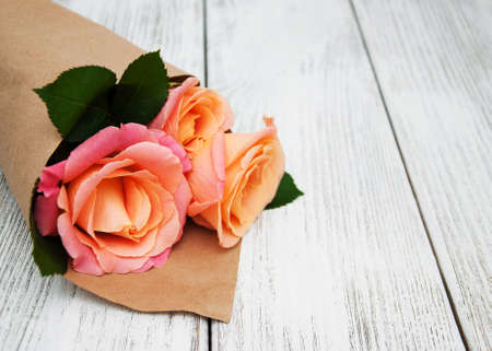 Pink roses on a old white wooden backgroundの写真素材