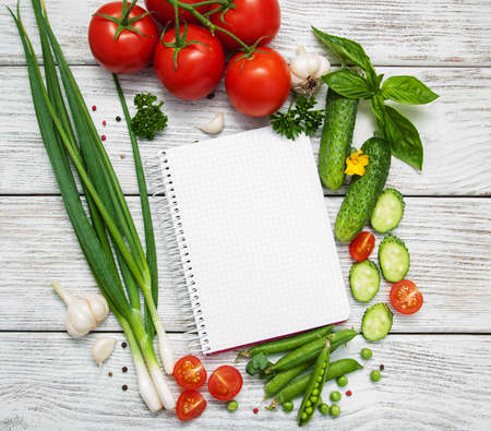 recipe planning concept with raw vegetables and ingredientsの写真素材