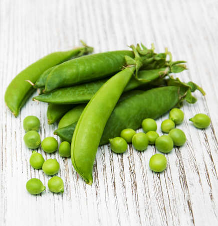 green peas  on rustic white wooden backgroundの写真素材